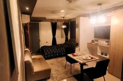 a small living room with a table and a couch at Blk Pod in Punta