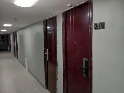 a row of doors in a hallway with the number at Blk Pod in Punta