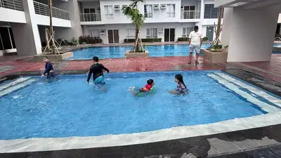 a group of people in a swimming pool at The Journeyman Suite at Covent Garden Sta Mesa Manila in Manila