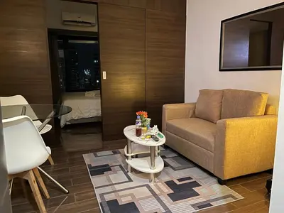 a living room with a couch and a table at Destina Stays @Air Residences Makati, MetroManila in Manila