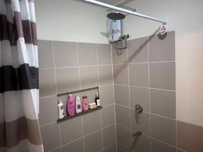 a bathroom with a shower with soap and shampoo at Casa Chena in Manila