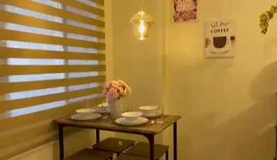 a small table with a vase of flowers on it at Casa Chena in Manila