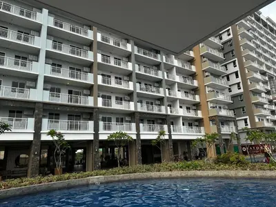 an apartment building with a pool in front of it at Casa Chena in Manila