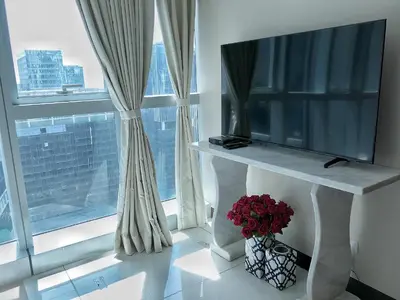 a room with a large window with a vase of flowers at Uptown BGC Taguig - One Bedroom in Manila