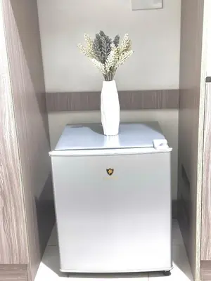 a white vase on top of a white refrigerator at Arkisha’s Cozy Place in Manila