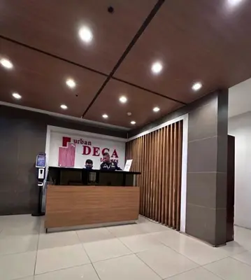 a lobby with a reception desk in a building at Arkisha’s Cozy Place in Manila
