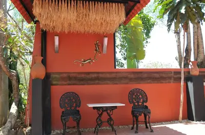 a table and two chairs in front of a building at Date & Dine Resort in Antipolo