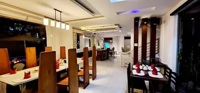 a restaurant with tables and chairs with red shoes on them at Date & Dine Resort in Antipolo