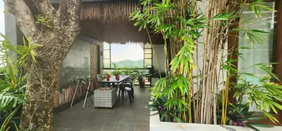 a room with a table and some plants at Date & Dine Resort in Antipolo
