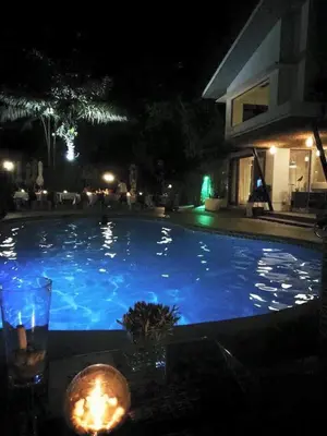 a swimming pool at night with a candle next to it at Date & Dine Resort in Antipolo