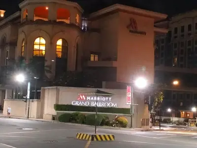a sign in front of a grand building at night at Nadzcondotel-2 Two Palmtree villas nearby NAIA Terminal 3 in Manila