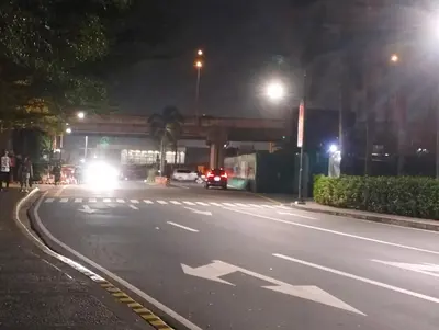 an empty street at night with cars driving at Nadzcondotel-2 Two Palmtree villas nearby NAIA Terminal 3 in Manila