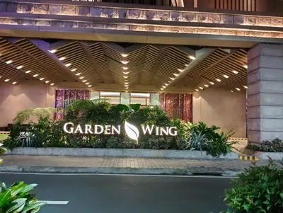 a garden wing sign in front of a building at Nadzcondotel-2 Two Palmtree villas nearby NAIA Terminal 3 in Manila
