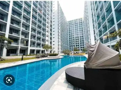 a swimming pool in a city with tall buildings at Shore 2 Staycation - Near Mall of Asia and Casinos in Manila