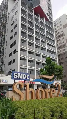 a large sign in front of a tall building at Shore 2 Staycation - Near Mall of Asia and Casinos in Manila