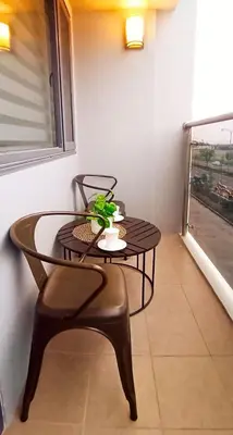 a table and a chair with a plant on it at The SPLENDOR Comfortable living by Awsom Phil in Manila