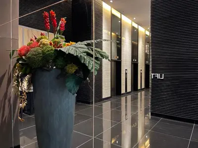 a large blue vase filled with flowers in a hallway at Destina Stays@ Air Residences Makati, Metro Manila in Manila