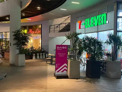 a mall with potted plants and a sign in it at Destina Stays@ Air Residences Makati, Metro Manila in Manila