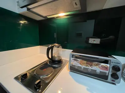 a toaster oven sitting on top of a kitchen counter at Destina Stays@ Air Residences Makati, Metro Manila in Manila