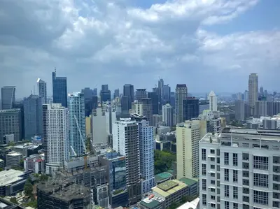 an aerial view of a city with tall buildings at Makati Penthouse with Stunning City Skyline View in Manila
