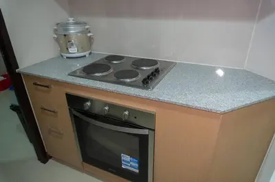 a kitchen with a stove and a counter top at A2J Luxury Uptown 3BR Suite Near Uptown Mall in Manila