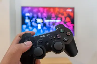 a person holding a sony video game controller at A2J Luxury Uptown 3BR Suite Near Uptown Mall in Manila