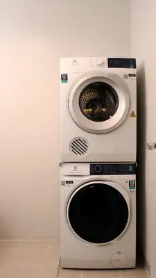 a washer and dryer stacked on top of each other at Aruga Apartments by Rockwell Makati in Manila