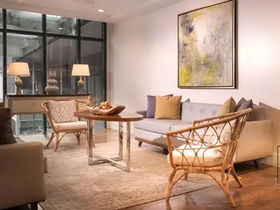 a living room with a couch and a table at Aruga Apartments by Rockwell Makati in Manila