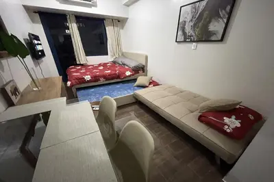 a living room with a couch and a bed at Luxury Air Residences By Makati in Manila