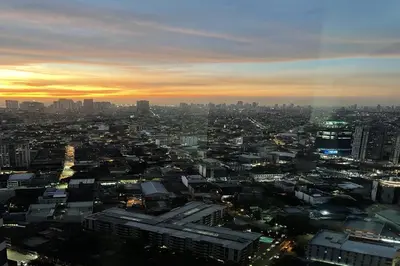 a view of a city at sunset at Luxury Air Residences By Makati in Manila
