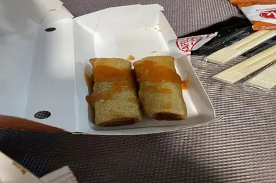 two pieces of bread in a white box on a table at Luxury Air Residences By Makati in Manila