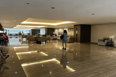 a woman standing in the middle of a hotel lobby at Luxury Air Residences By Makati in Manila