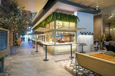 a restaurant with a counter in the middle of a building at Amazing Unit and View in Uptown Parksuites BGC in Manila