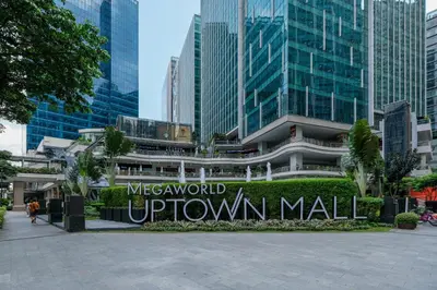 a sign that reads welcome to the city of uptown mall at Amazing Unit and View in Uptown Parksuites BGC in Manila