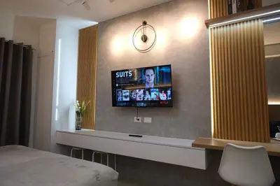 a hotel room with a tv on the wall at Staycation near Mall of Asia, Condotel with King Bed in Manila