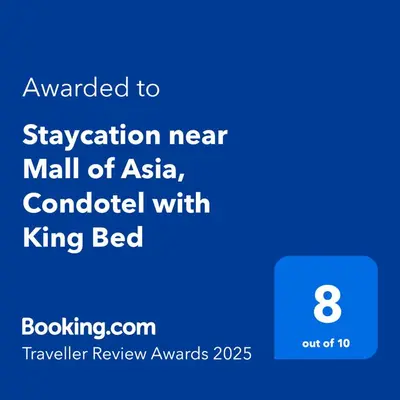 a screenshot of a phone with the text upgraded to vacation near mall of asia at Staycation near Mall of Asia, Condotel with King Bed in Manila