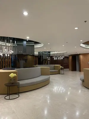a lobby with couches and tables in a building at Staycation near Mall of Asia, Condotel with King Bed in Manila