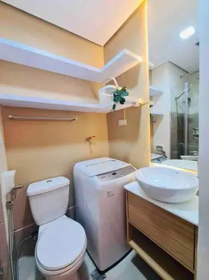 a bathroom with a toilet and a sink at Jeced Condotel at Spring Residences near Airport in Manila