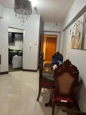 a dining room with a table and chairs and a chandelier at Montecito HOME AWAY FROM HOME, across NAIA Terminal 3 in Manila