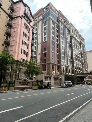 a large pink building on the side of a street at Montecito HOME AWAY FROM HOME, across NAIA Terminal 3 in Manila