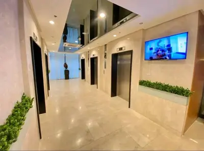a hallway in a building with a tv on the wall at Skyia's Pod a Premier Suite at Shore 2 Residences in Manila