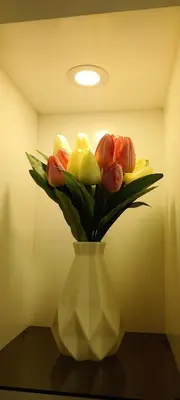 a vase filled with colorful flowers on a table at Skyia's Pod a Premier Suite at Shore 2 Residences in Manila