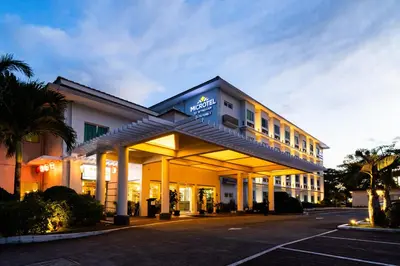 a hotel with a sign on the front of it at Microtel by Wyndham South Forbes near Nuvali in Santa Rosa