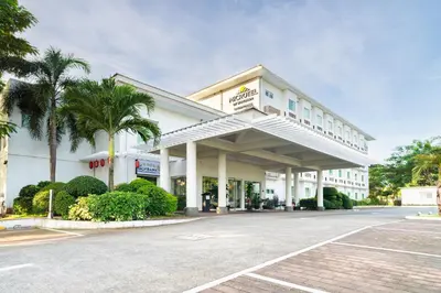 a hotel with a parking lot in front of it at Microtel by Wyndham South Forbes near Nuvali in Santa Rosa