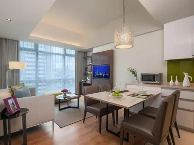 a kitchen and living room with a table and chairs at Citadines Salcedo Makati in Manila