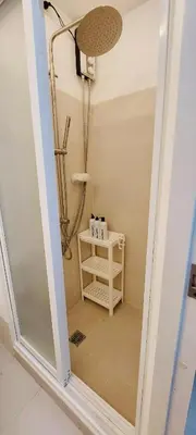 a shower with a glass door in a bathroom at Casa Lim SMDC Light Residences Tower 3 in Manila