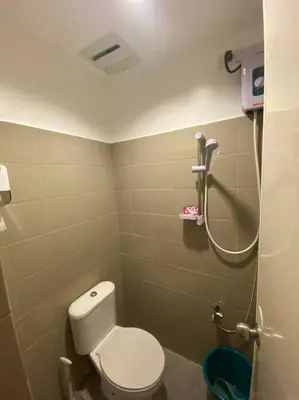 a small bathroom with a toilet and a shower at El Pueblo Studio - Manila in Manila