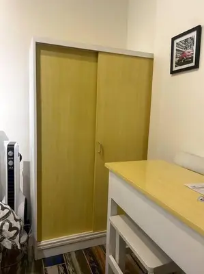 a green door in a room with a desk at El Pueblo Studio - Manila in Manila