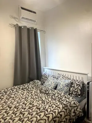 a bedroom with a bed and a window at El Pueblo Studio - Manila in Manila