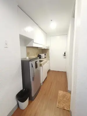 a kitchen with a stainless steel refrigerator in a room at warm makati in Manila